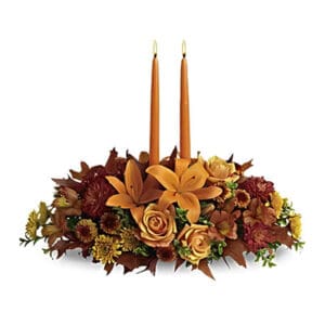 Autumnal centerpiece with two candles.