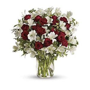 Red roses and white lilies in vase.