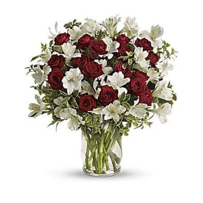 Red roses and white lilies in vase.