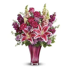 Pink lilies and roses in vase.