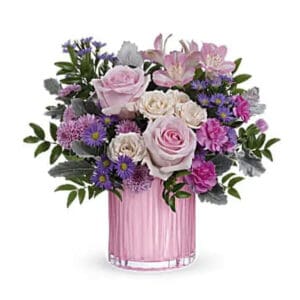 Pink and purple flowers in pink vase.