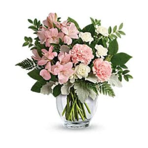 Pink and white flower bouquet in vase.