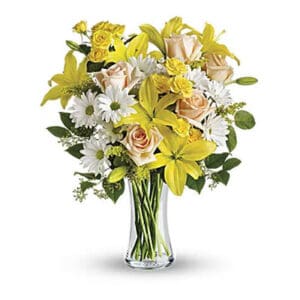 Yellow and white flowers in a vase.