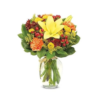 Autumnal flower bouquet in glass vase.